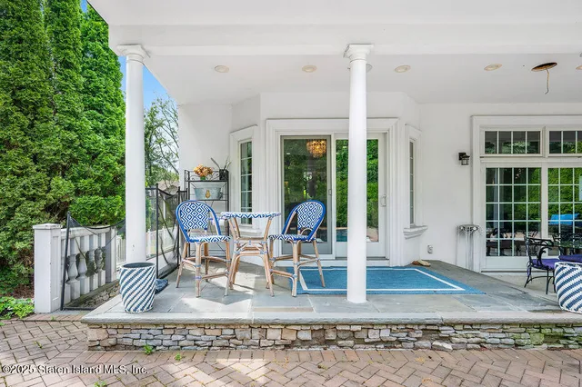 a view of a patio with table and chairs
