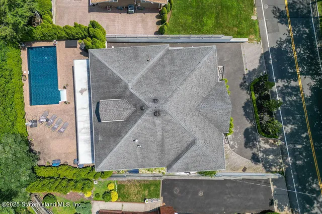 an aerial view of a house with a yard