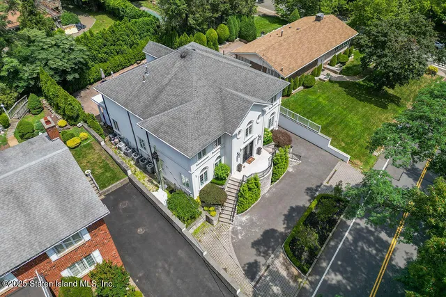 an aerial view of a house with a yard