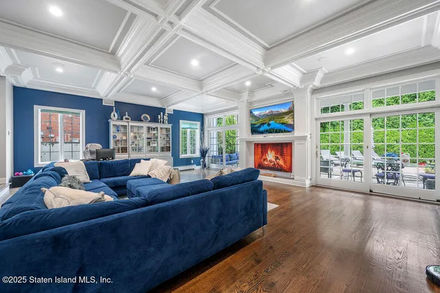 a living room with fireplace furniture and a large window
