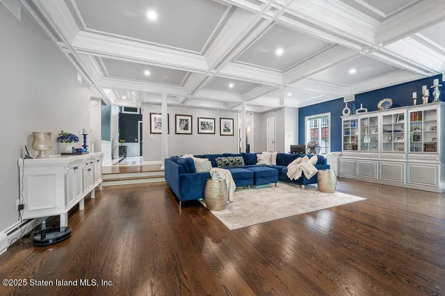a living room with furniture window and wooden floor