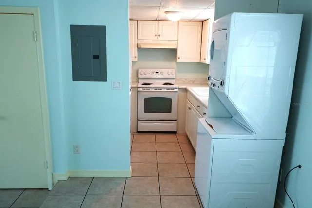a kitchen with a white stove and refrigerator