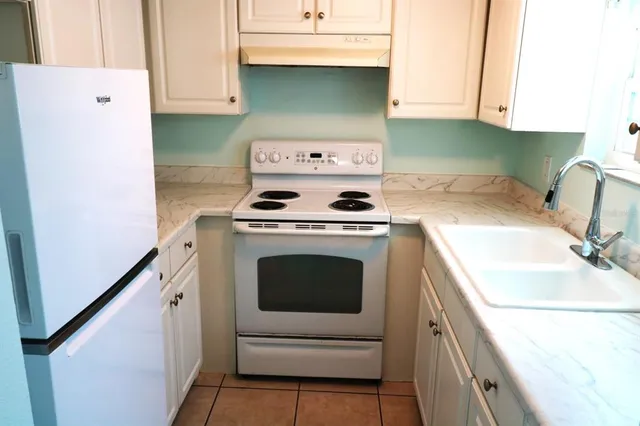 a kitchen with a stove and a refrigerator