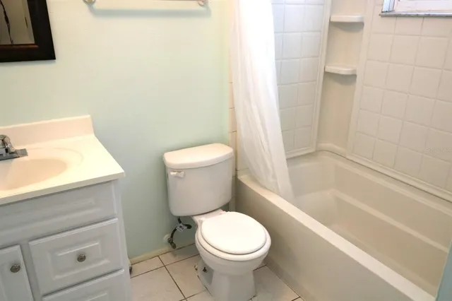 a white toilet sitting next to a bath tub