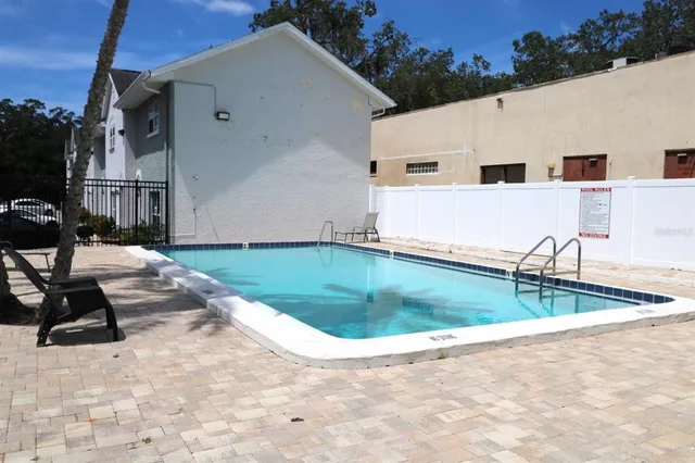a view of a house with backyard and sitting area