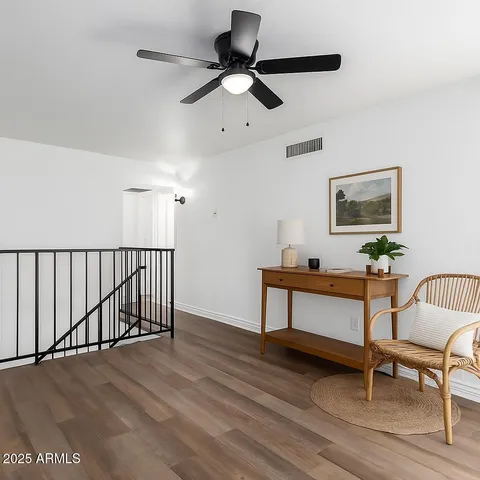 a bedroom with bed and wooden floor