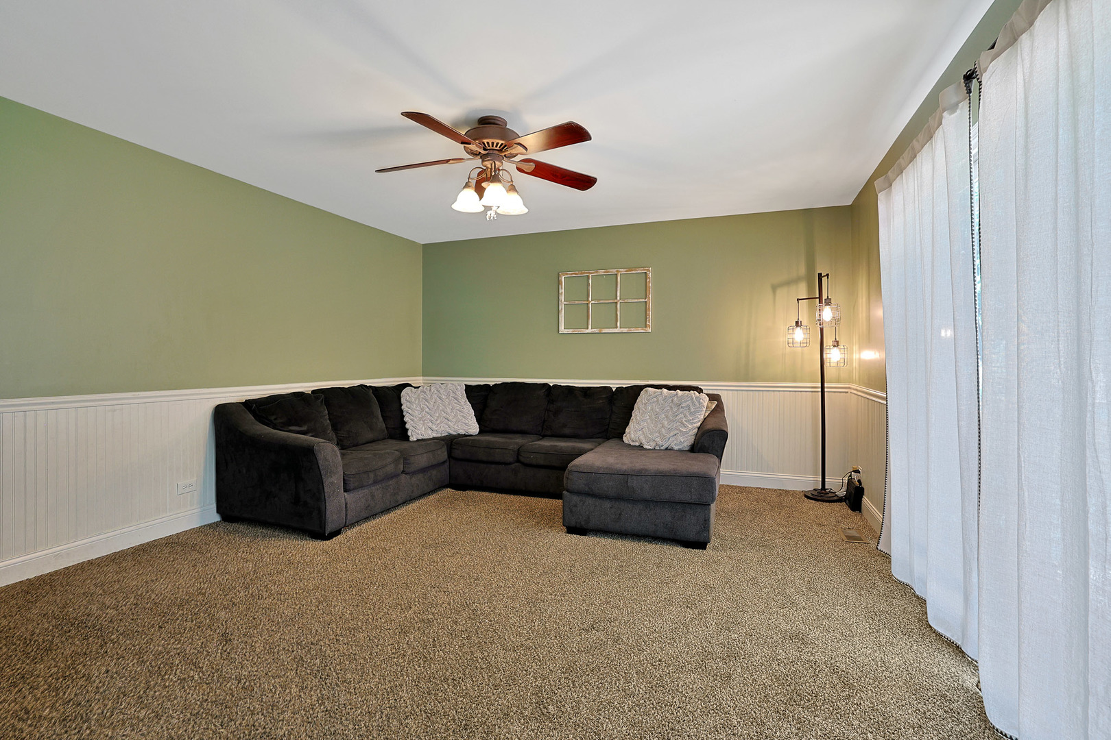 710 Cimarron Drive Cary, IL 60013 - Photo 12 of 31 a living room with furniture and a chandelier