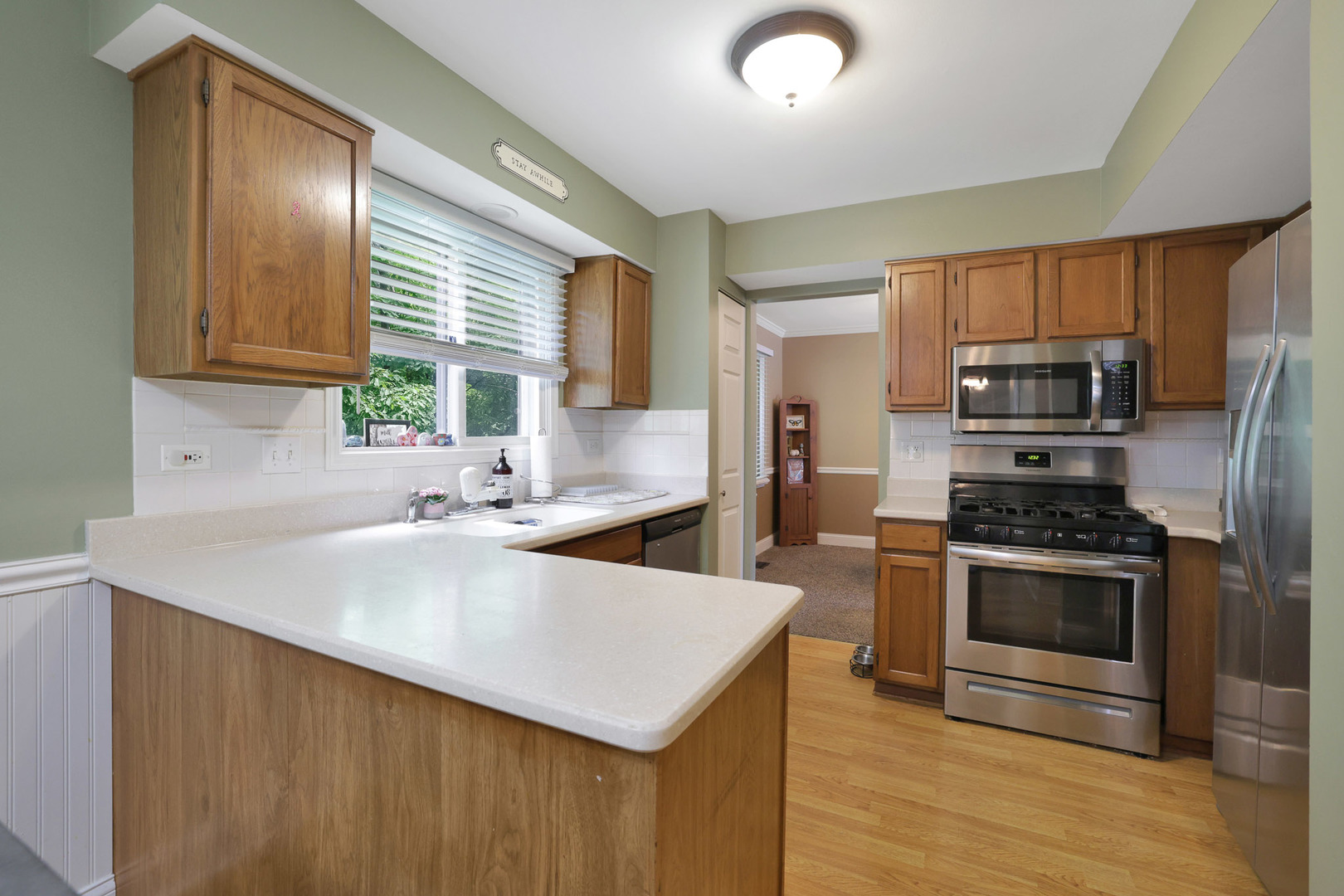 710 Cimarron Drive Cary, IL 60013 - Photo 16 of 31 a kitchen with a stove a sink and a refrigerator