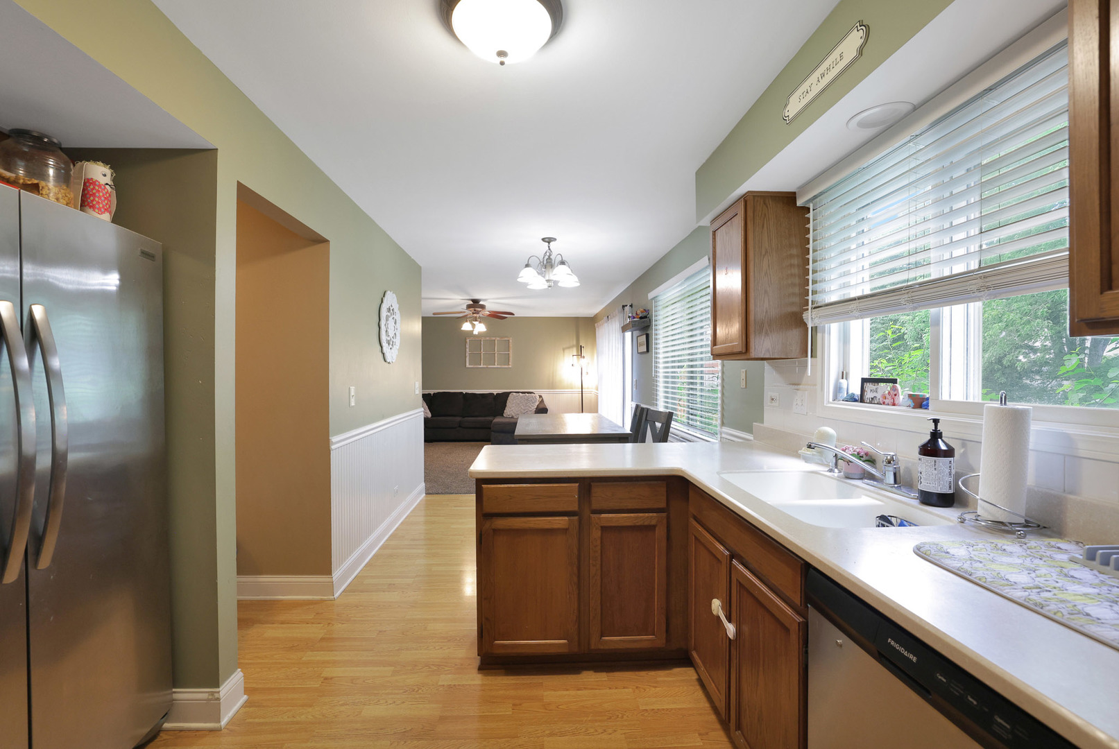 710 Cimarron Drive Cary, IL 60013 - Photo 18 of 31 a kitchen with a sink dishwasher a refrigerator and cabinets