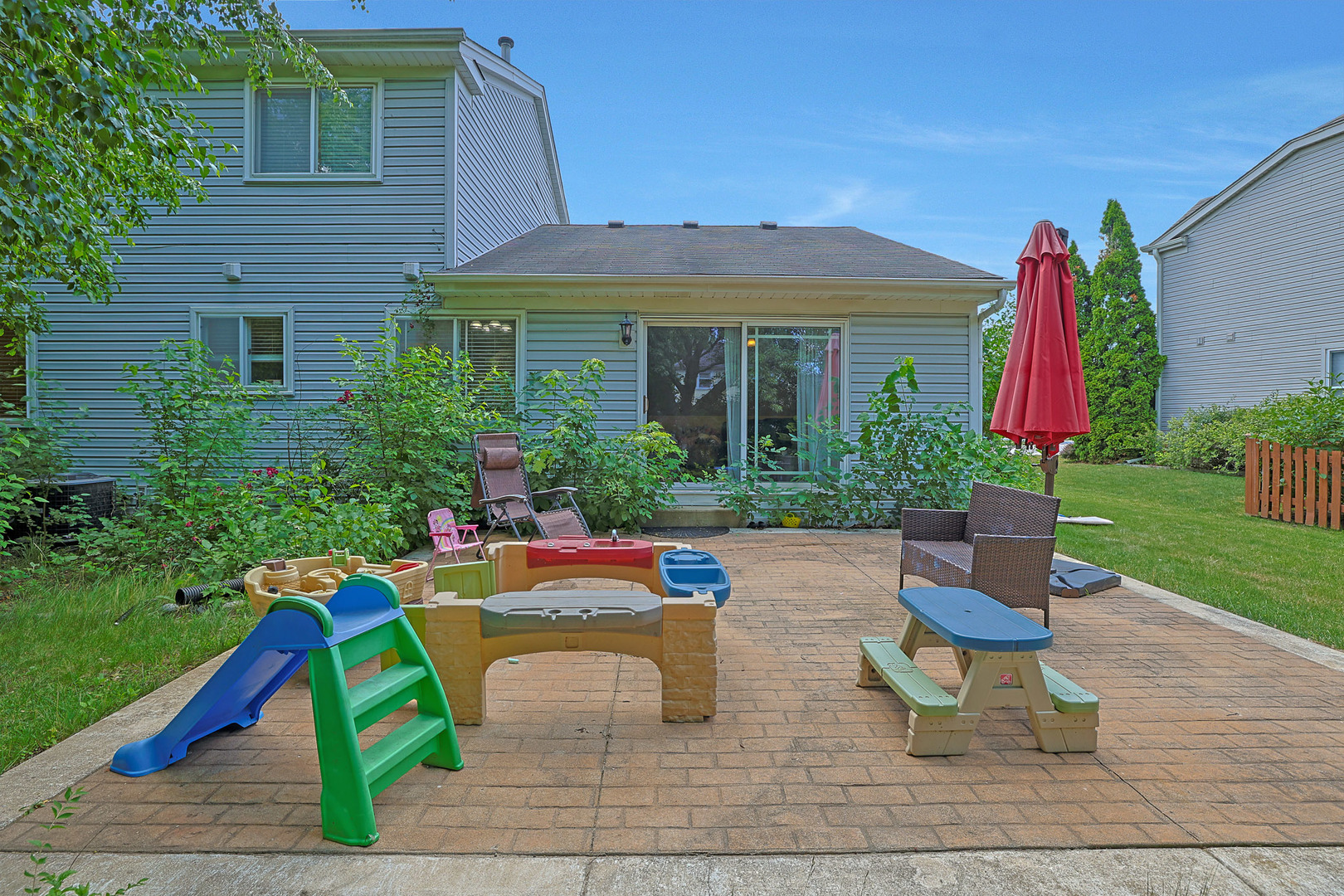710 Cimarron Drive Cary, IL 60013 - Photo 24 of 31 a view of a house with a yard patio and a slide