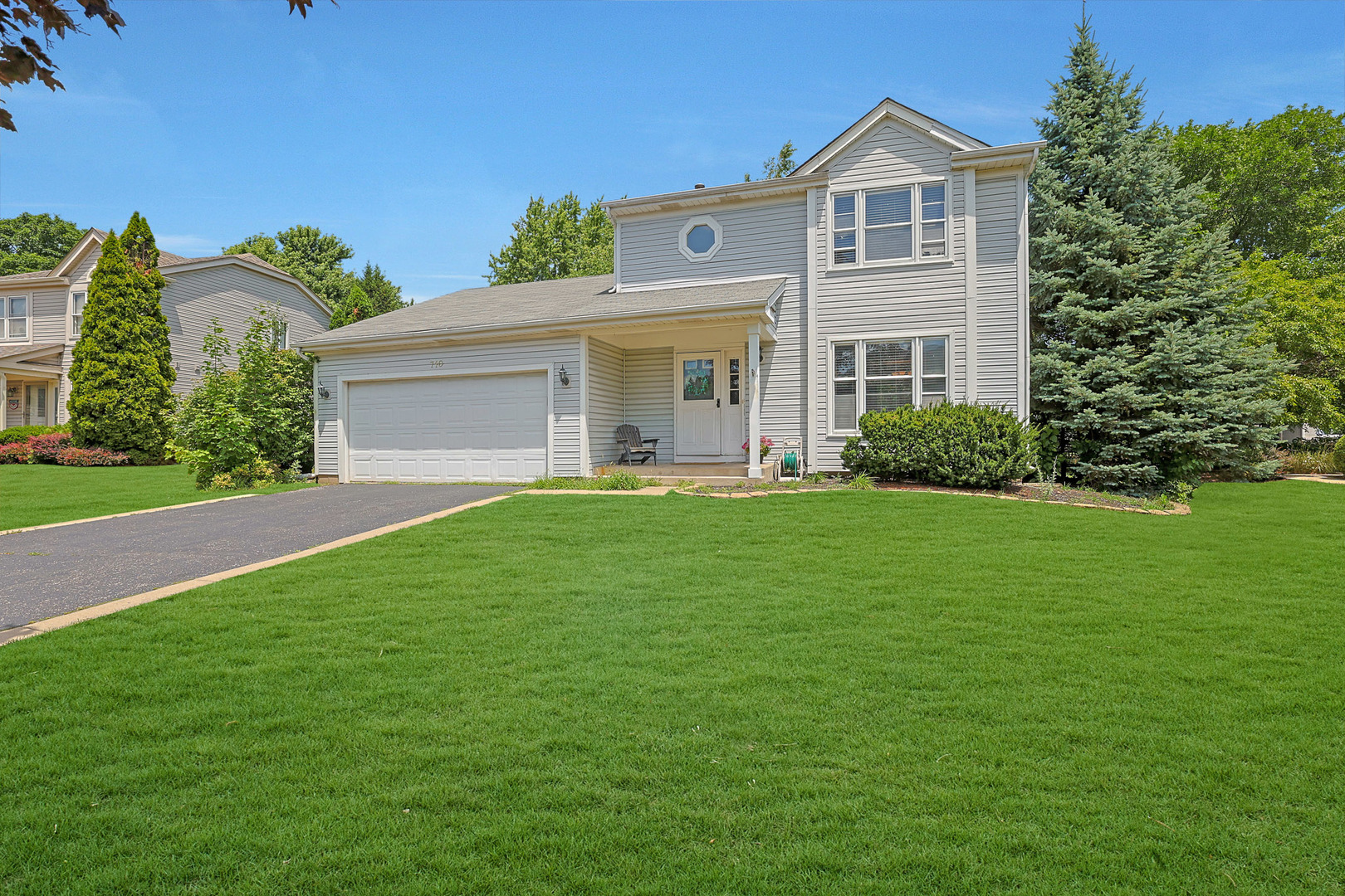 710 Cimarron Drive Cary, IL 60013 - Photo 28 of 31 a front view of a house with a yard and trees
