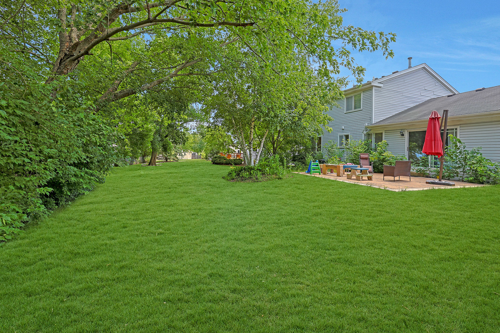 710 Cimarron Drive Cary, IL 60013 - Photo 29 of 31 a view of a house with a big yard and potted plants