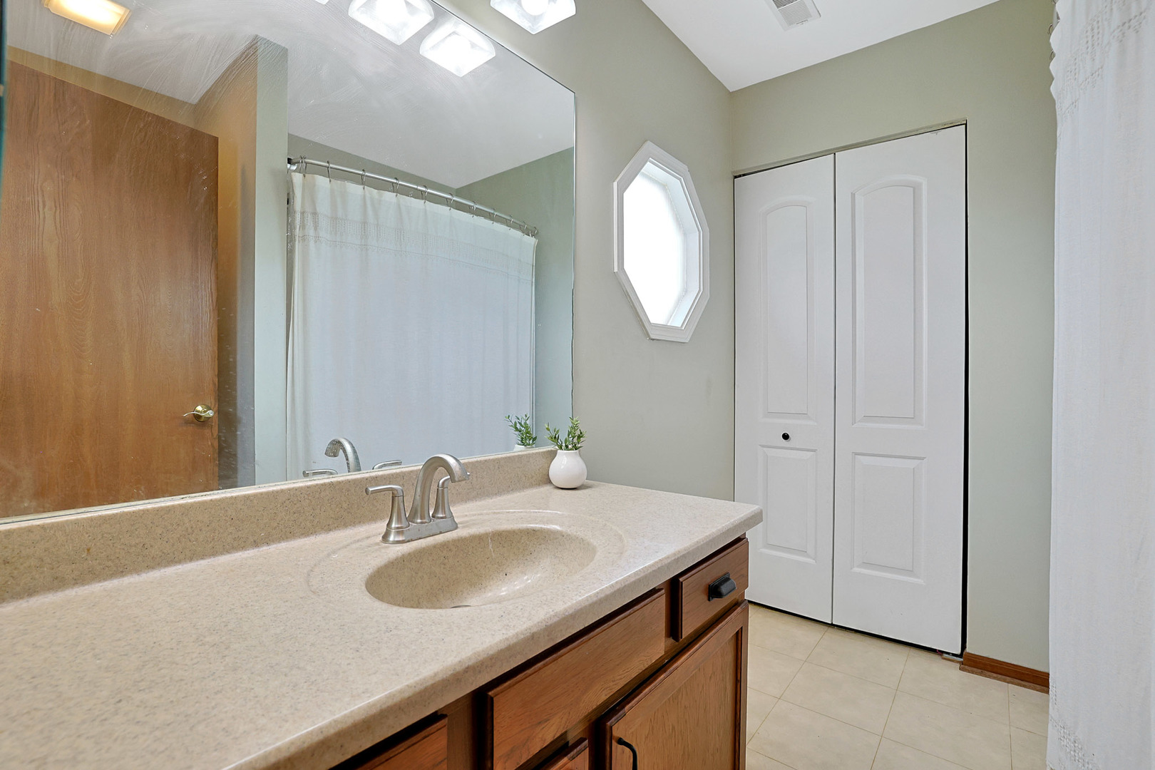 710 Cimarron Drive Cary, IL 60013 - Photo 5 of 31 a bathroom with a sink and a mirror