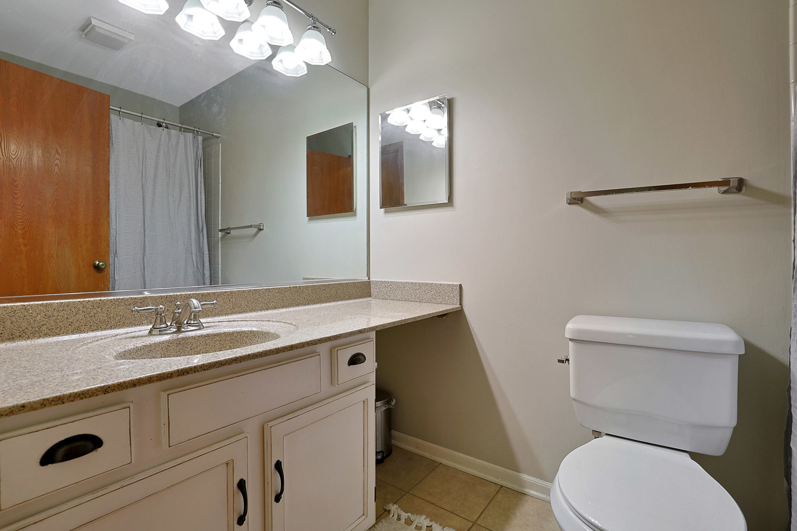 710 Cimarron Drive Cary, IL 60013 - Photo 8 of 31 a bathroom with a granite countertop toilet sink and mirror