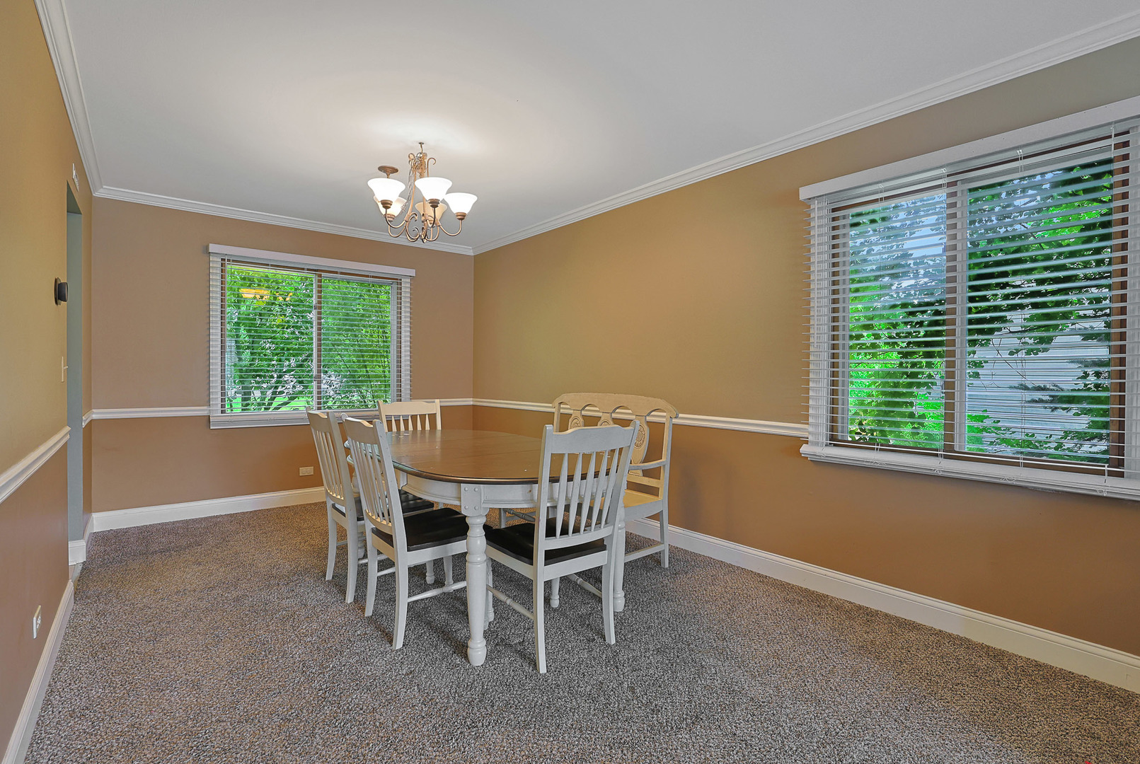 710 Cimarron Drive Cary, IL 60013 - Photo 10 of 31 a dining room with furniture a chandelier and window