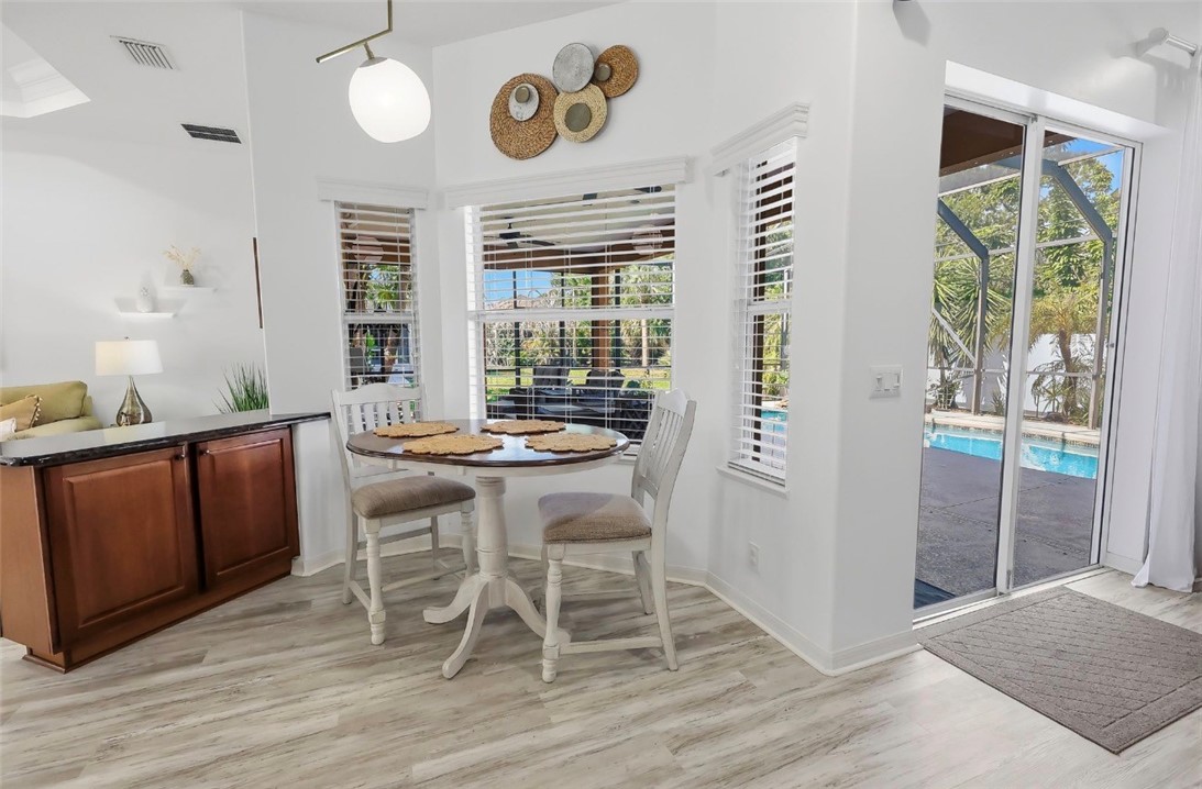1771 Mistletoe Street Sebastian, FL 32958 - Photo 7 of 36 a view of a dining room with furniture window and wooden floor