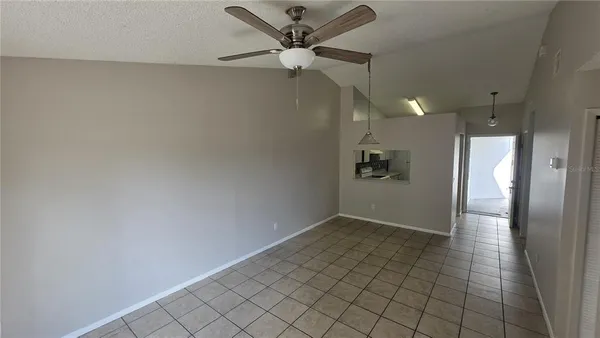 an empty room with fan and a ceiling fan