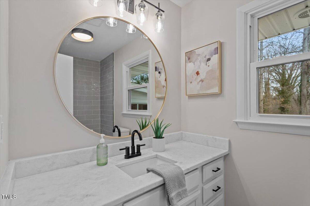 3408 Brentwood Road Raleigh, NC 27604 - Photo 16 of 41 a bathroom with a sink and a mirror