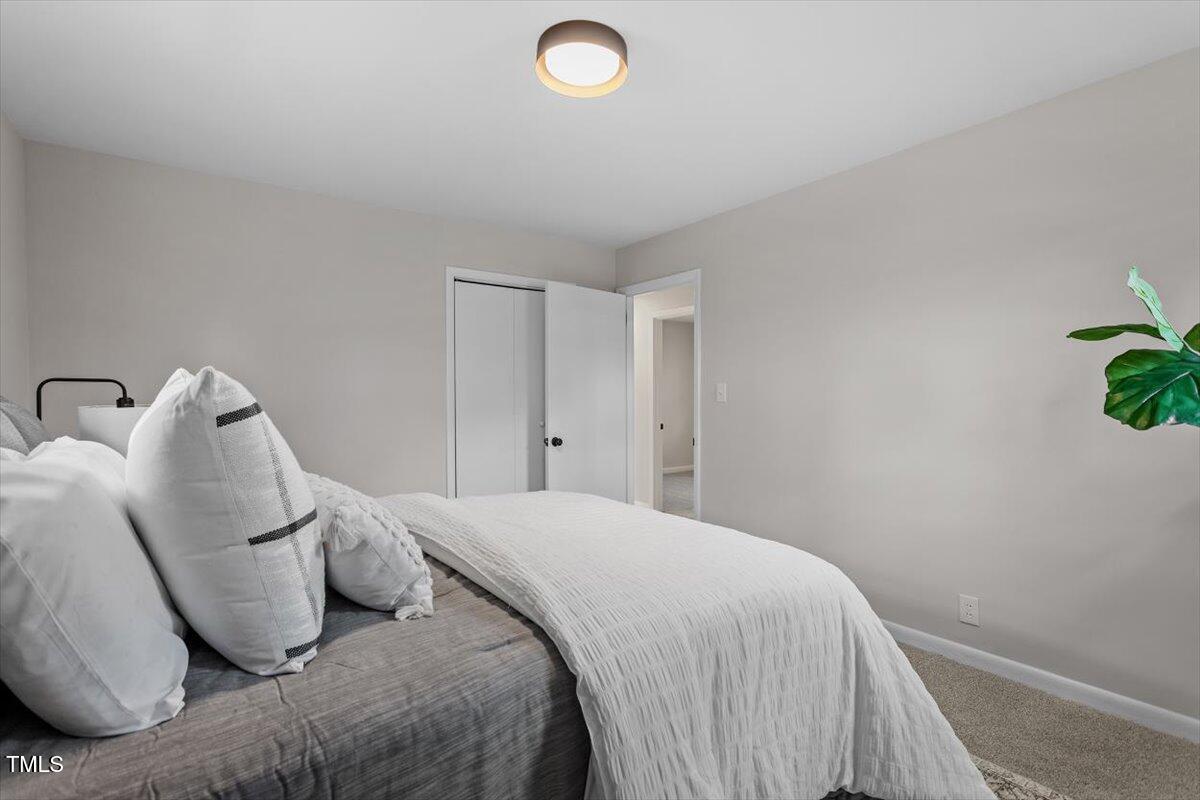3408 Brentwood Road Raleigh, NC 27604 - Photo 17 of 41 a bedroom with a bed and a potted plant