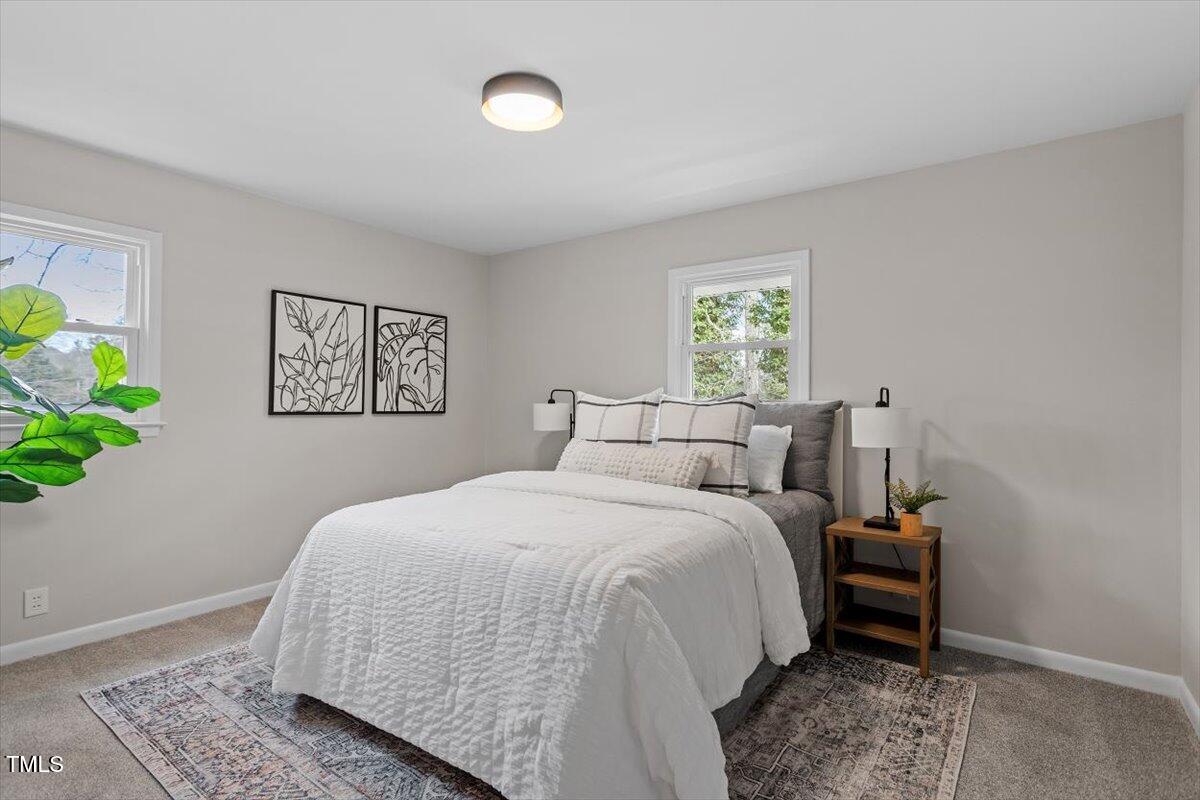 3408 Brentwood Road Raleigh, NC 27604 - Photo 19 of 41 a bedroom with a bed and a window