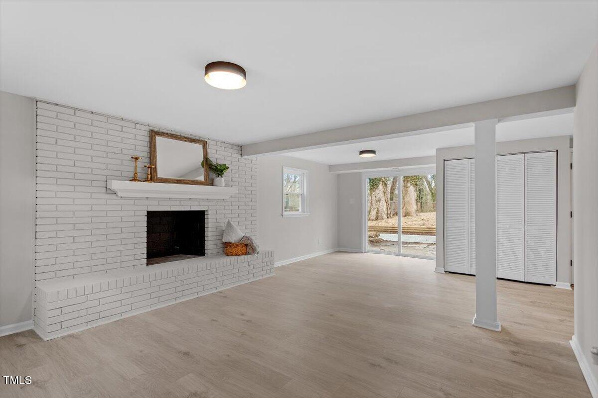 3408 Brentwood Road Raleigh, NC 27604 - Photo 24 of 41 a view of an empty room with a fireplace and a window