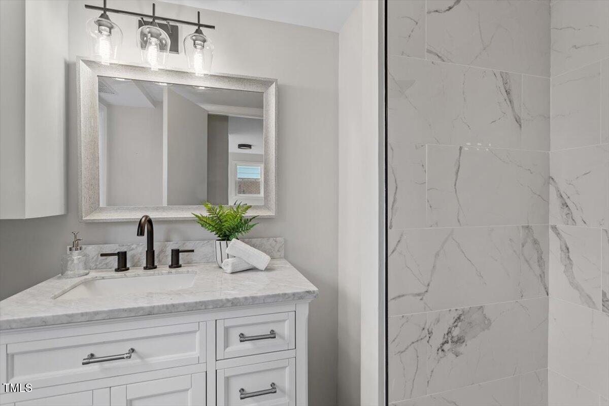 3408 Brentwood Road Raleigh, NC 27604 - Photo 27 of 41 a bathroom with a sink and a mirror
