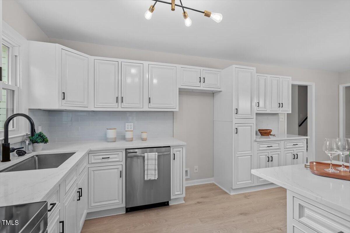 3408 Brentwood Road Raleigh, NC 27604 - Photo 7 of 41 a kitchen with cabinets appliances a sink and a counter space