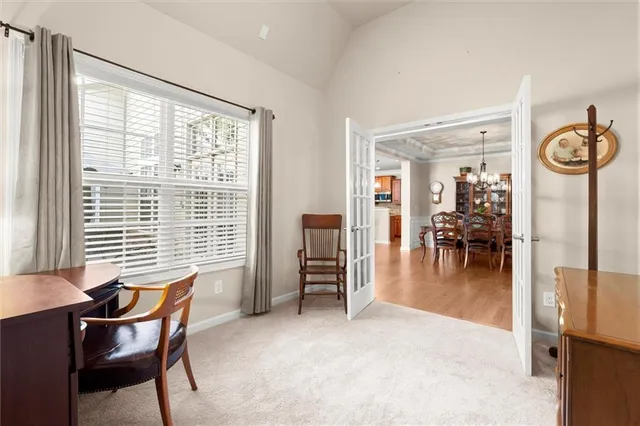 a dining room with furniture and a large window