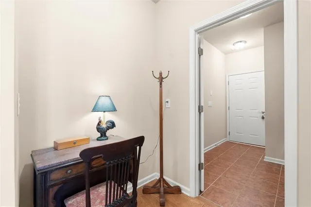 a view of a workspace with furniture and a bathroom