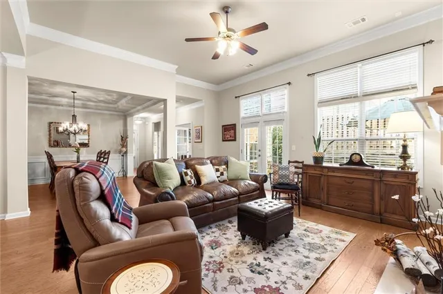 a living room with furniture fireplace and a large window