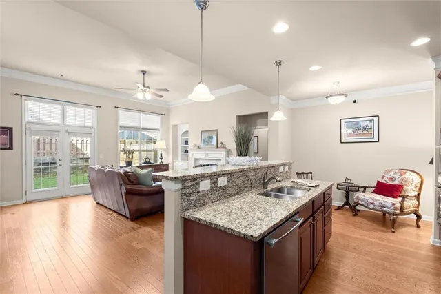 a living room with granite countertop kitchen island furniture and a chandelier