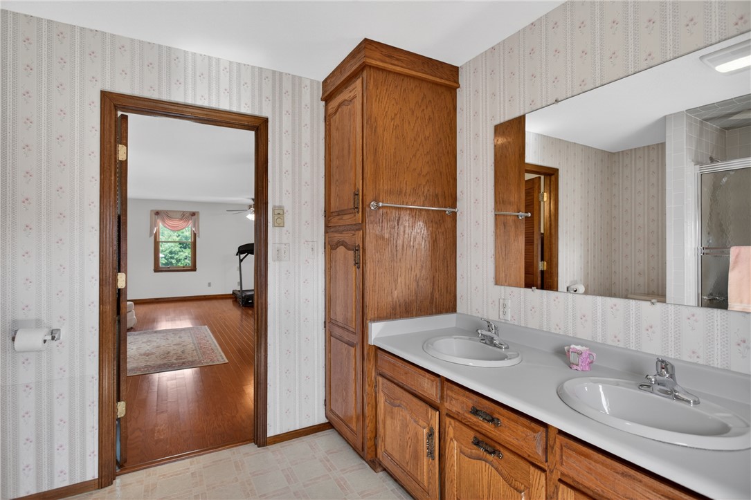 145 State Rd S-4-935 Pendleton, SC 29670 - Photo 21 of 47 Double vanity with ample counter space and warm wooden cabinetry offers functional elegance.