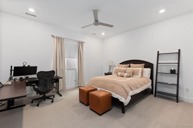 a bedroom with a bed and a chair