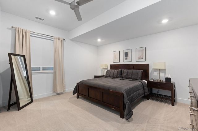 a spacious bedroom with a bed and a couch