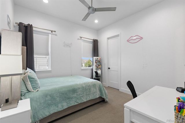 a bedroom with a bed and a large mirror