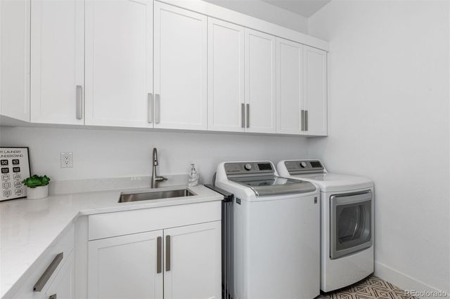 a kitchen with stainless steel appliances granite countertop white cabinets sink and dishwasher