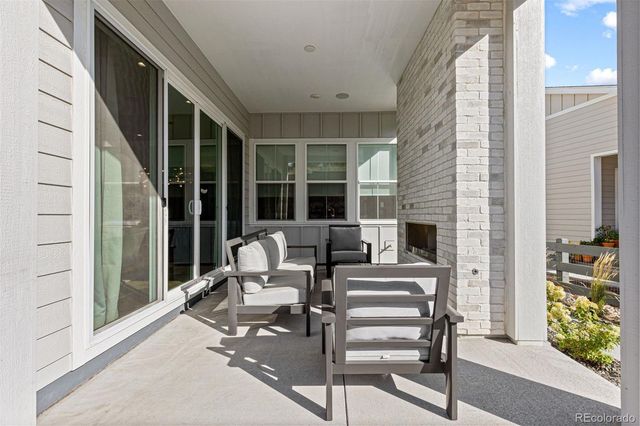 a view of a patio with table and chairs and potted plants