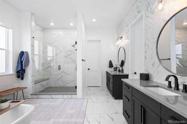 a bathroom with a double vanity sink mirror and shower