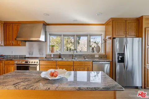 a kitchen that has a table and chairs in it