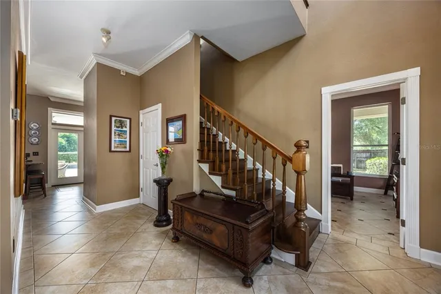 a view of backyard with table and chairs and floor to ceiling window