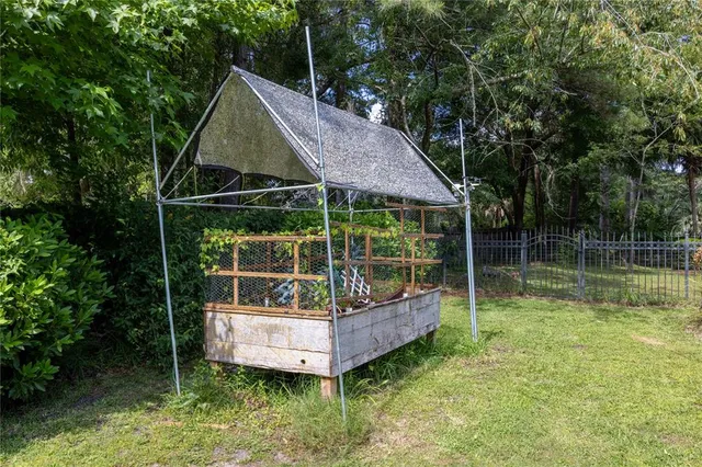 a view of house with outdoor space and garden