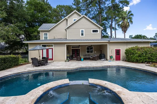 an aerial view of a house with yard swimming pool and outdoor seating
