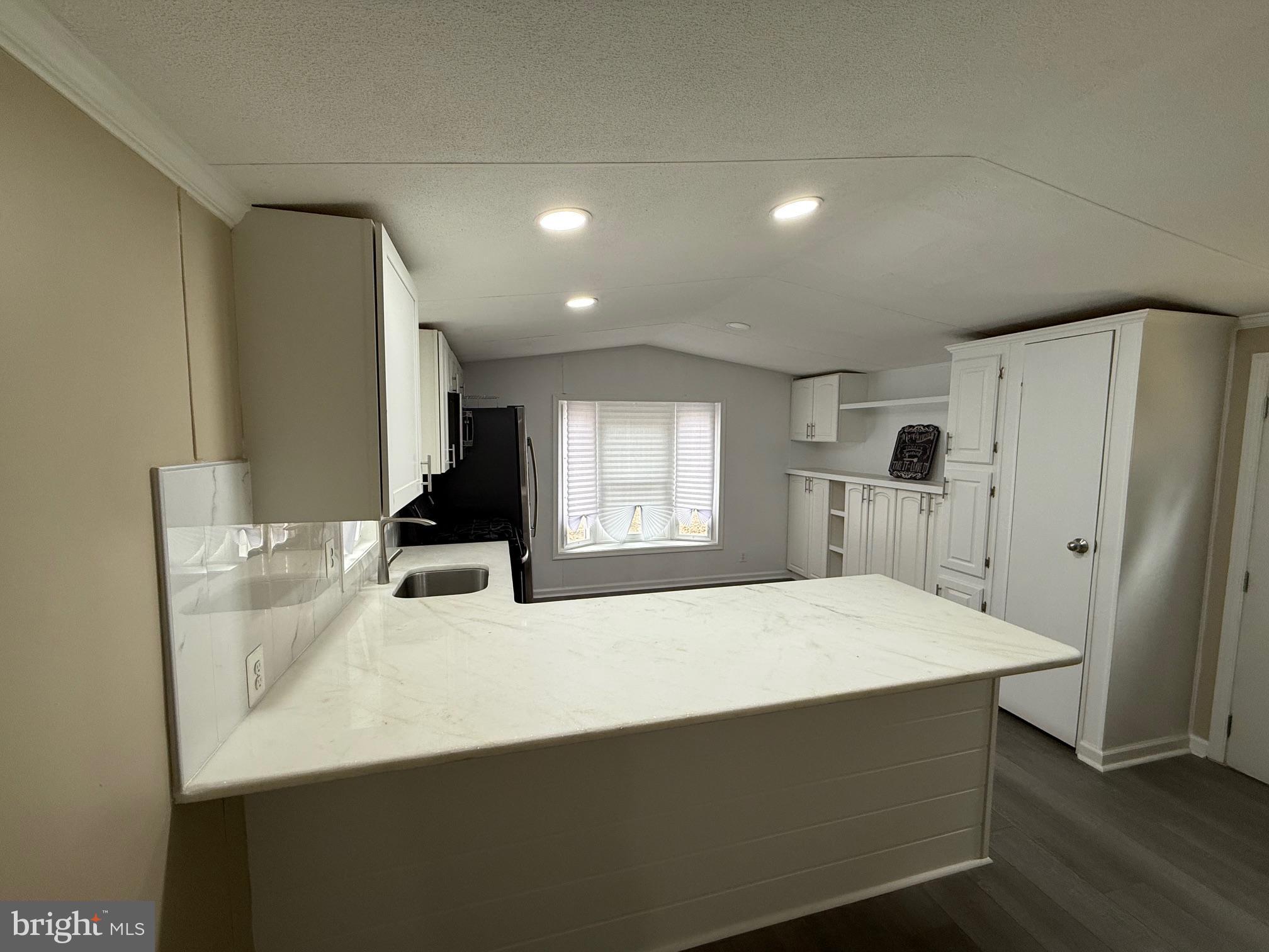 21182 Marsh Creek Road Preston, MD 21655 - Photo 3 of 9 a kitchen with stainless steel appliances a refrigerator and a stove