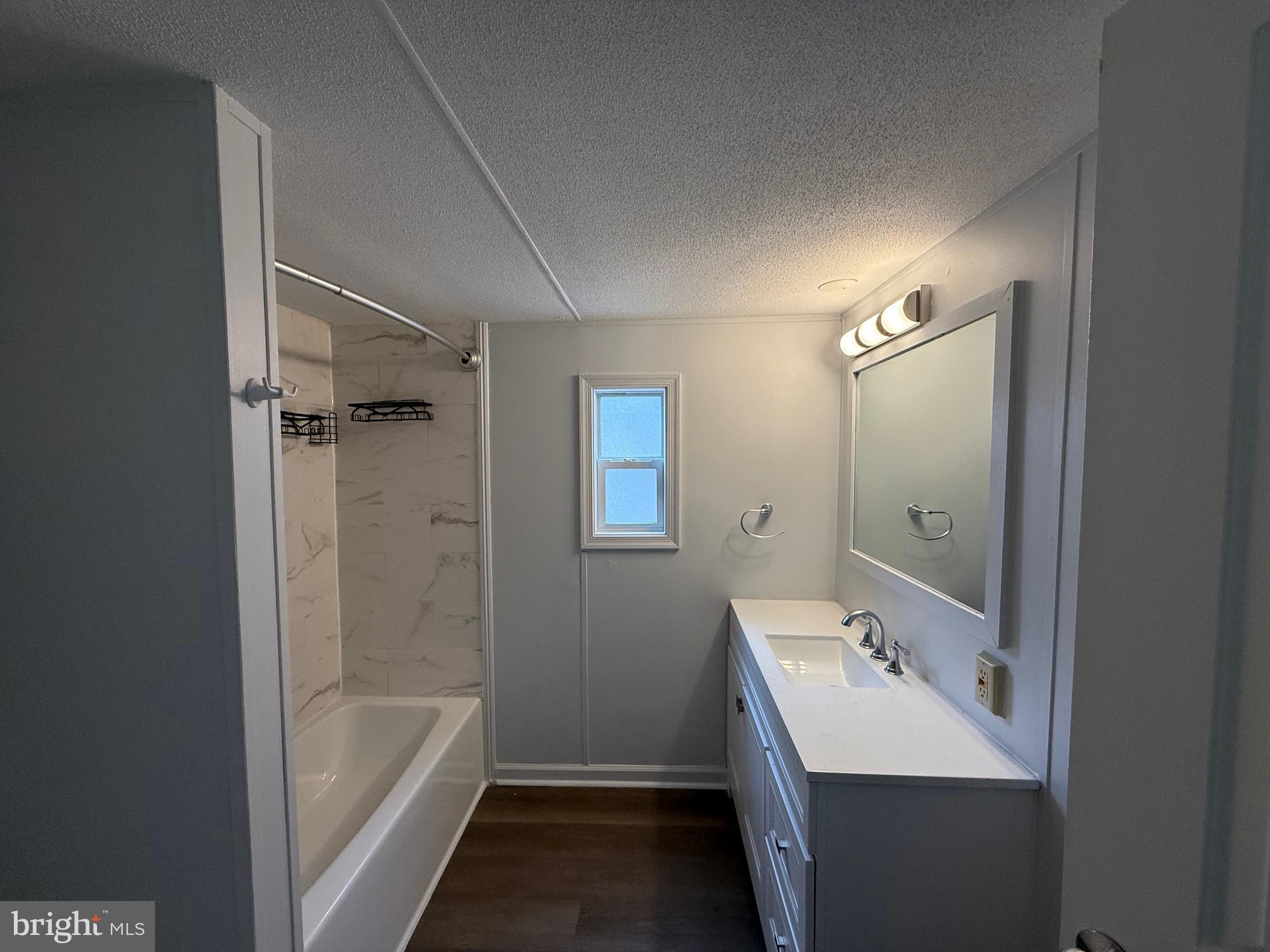 21182 Marsh Creek Road Preston, MD 21655 - Photo 6 of 9 a bathroom with a tub sink and mirror