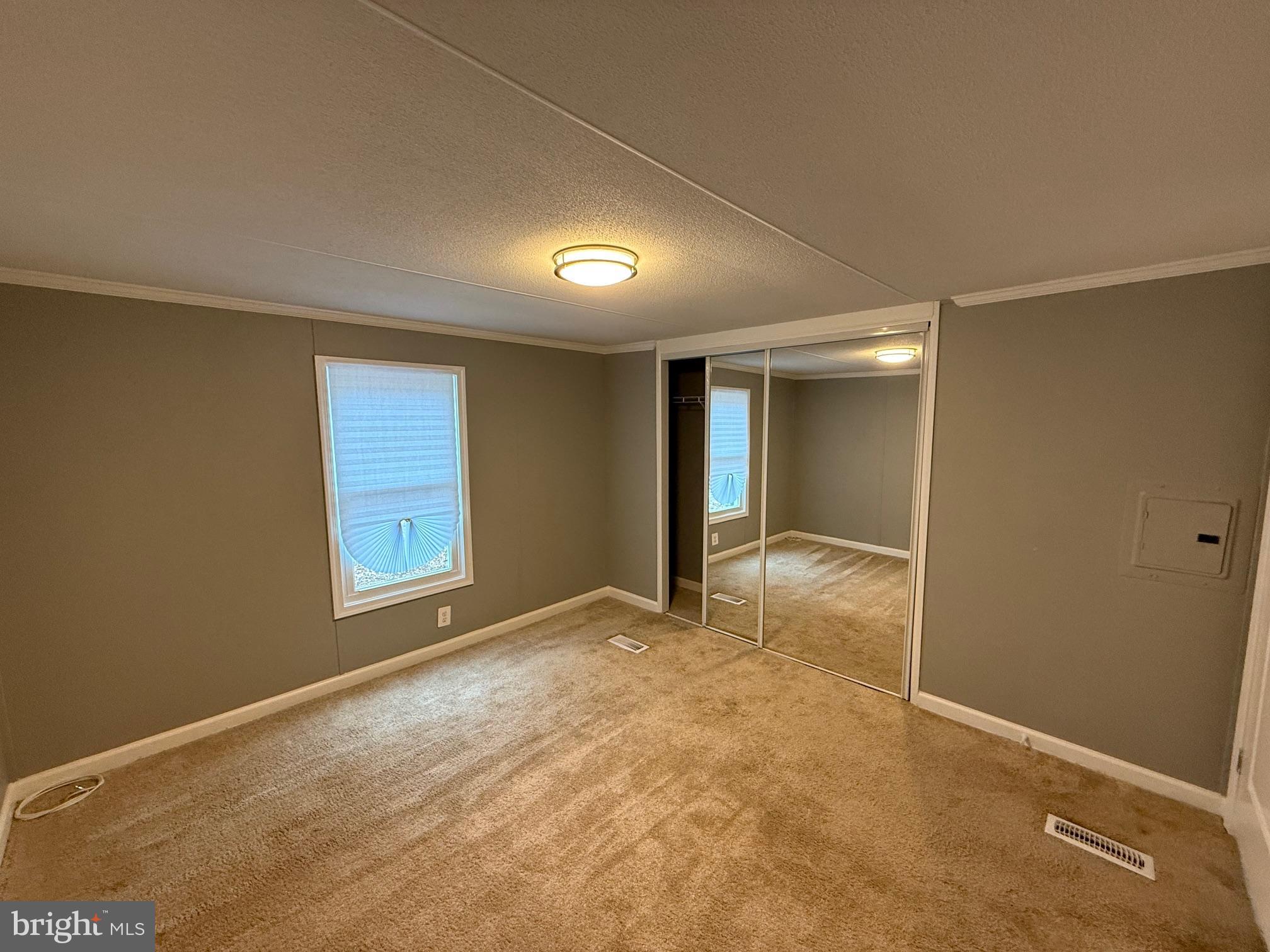 21182 Marsh Creek Road Preston, MD 21655 - Photo 7 of 9 an empty room with windows