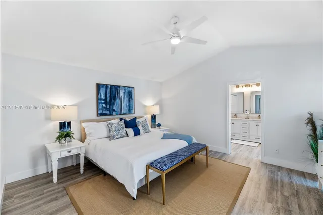 a bed room with a bed and a chandelier