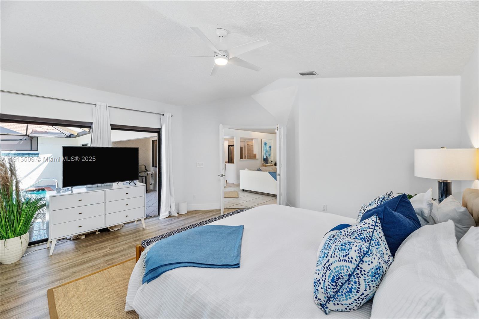 701 Sea Oats Drive, Unit D1 Juno Beach, FL 33408 - Photo 13 of 27 a bedroom with a bed and a flat screen tv