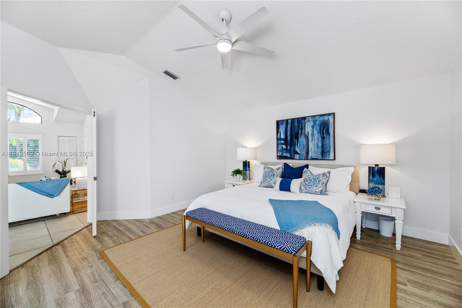 701 Sea Oats Drive, Unit D1 Juno Beach, FL 33408 - Photo 14 of 27 a bedroom with a bed and a chandelier