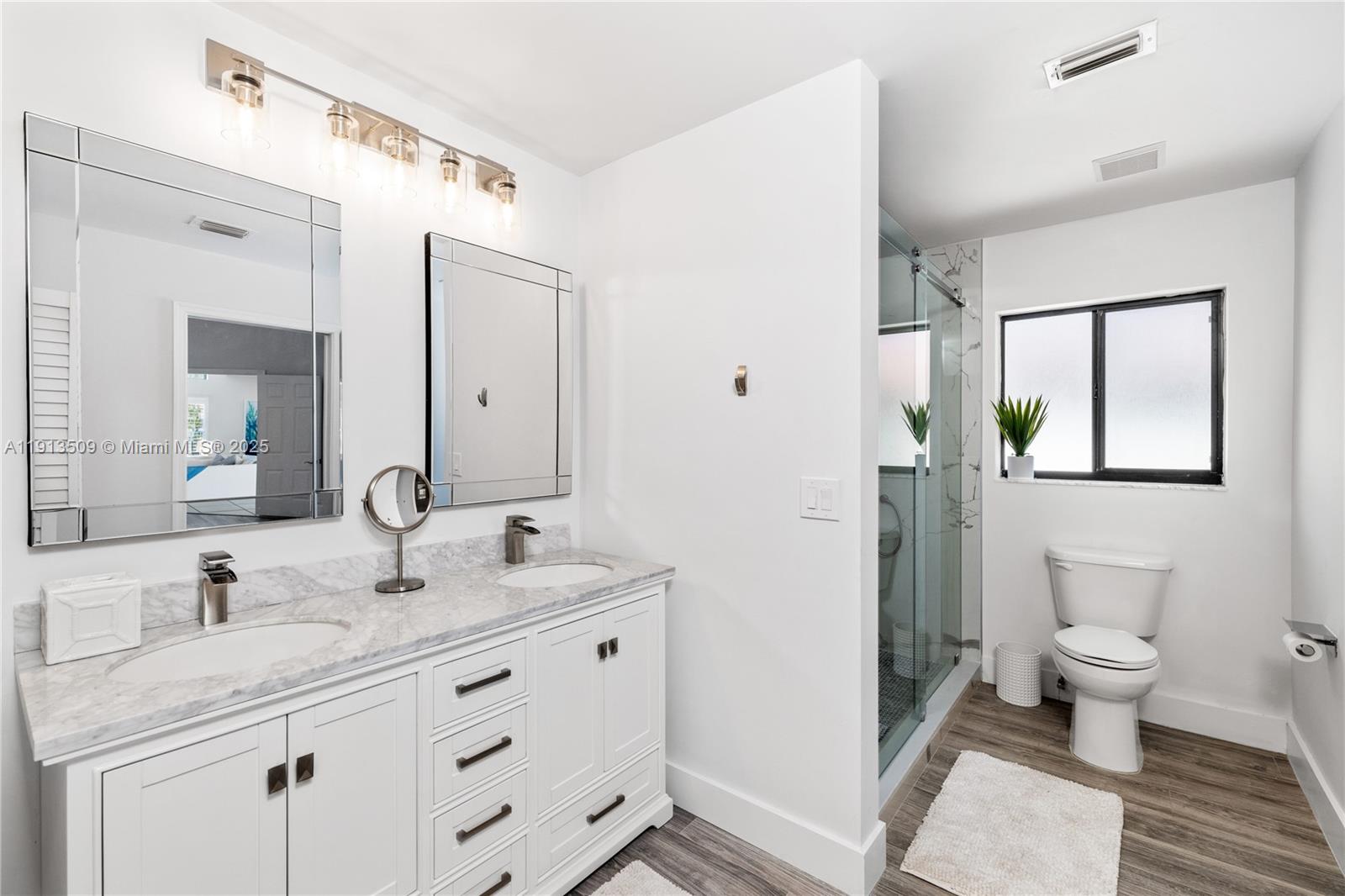 701 Sea Oats Drive, Unit D1 Juno Beach, FL 33408 - Photo 15 of 27 a bathroom with a granite countertop sink toilet and shower
