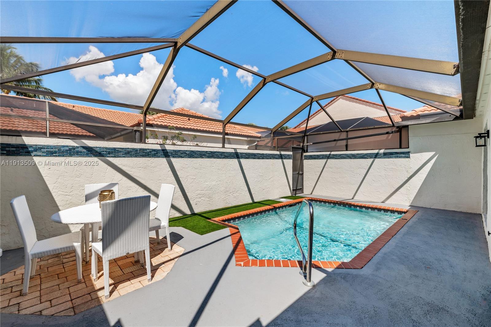 701 Sea Oats Drive, Unit D1 Juno Beach, FL 33408 - Photo 18 of 27 a view of a chairs and table in the patio